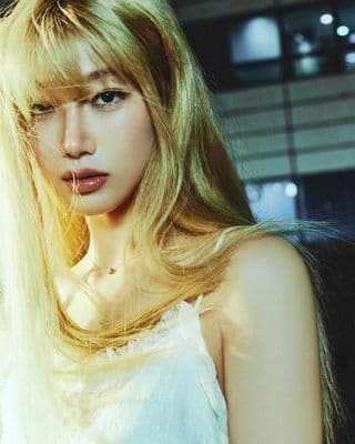 a woman with long blonde hair posing for a picture