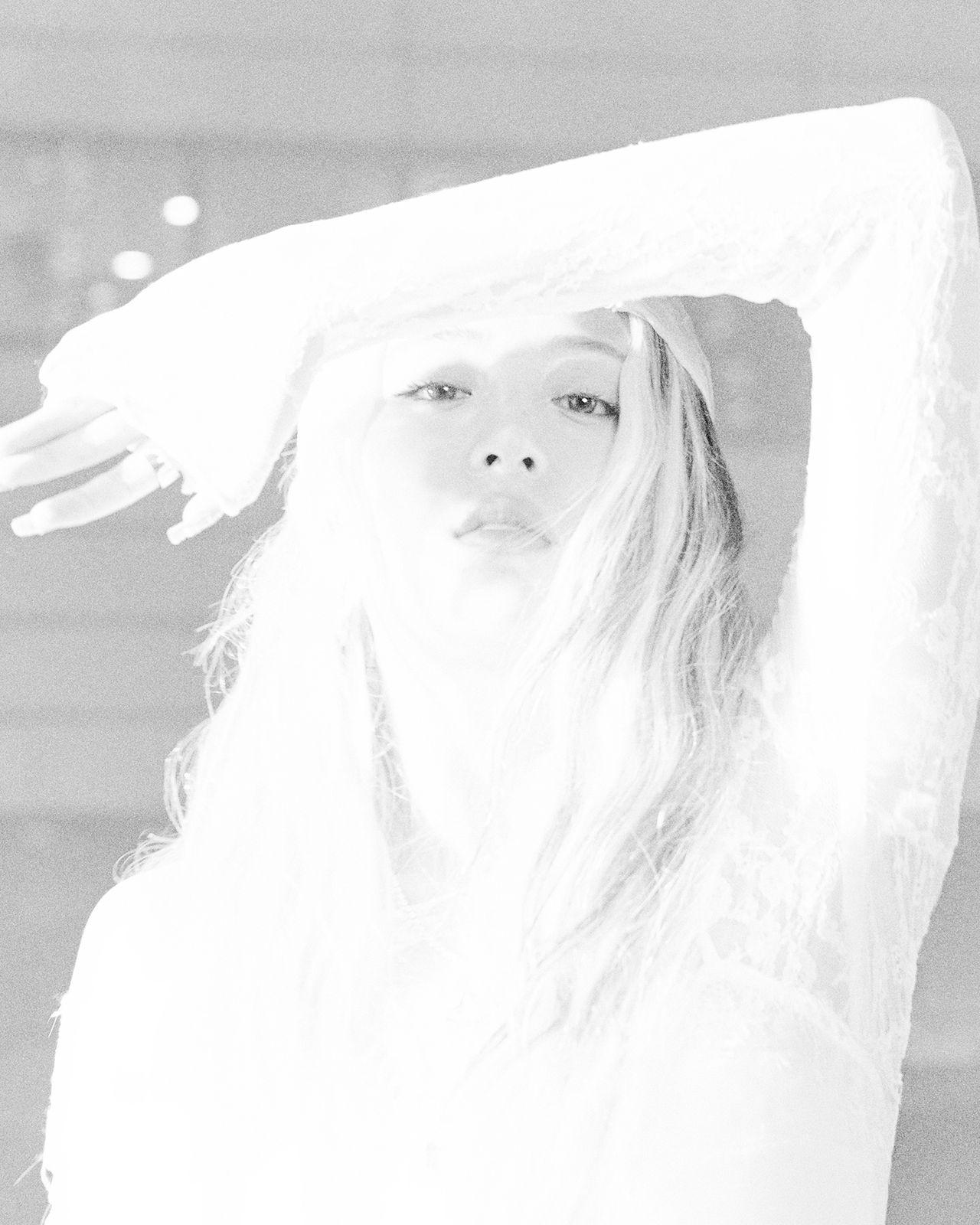 a black and white photo of a woman with a veil on her head
