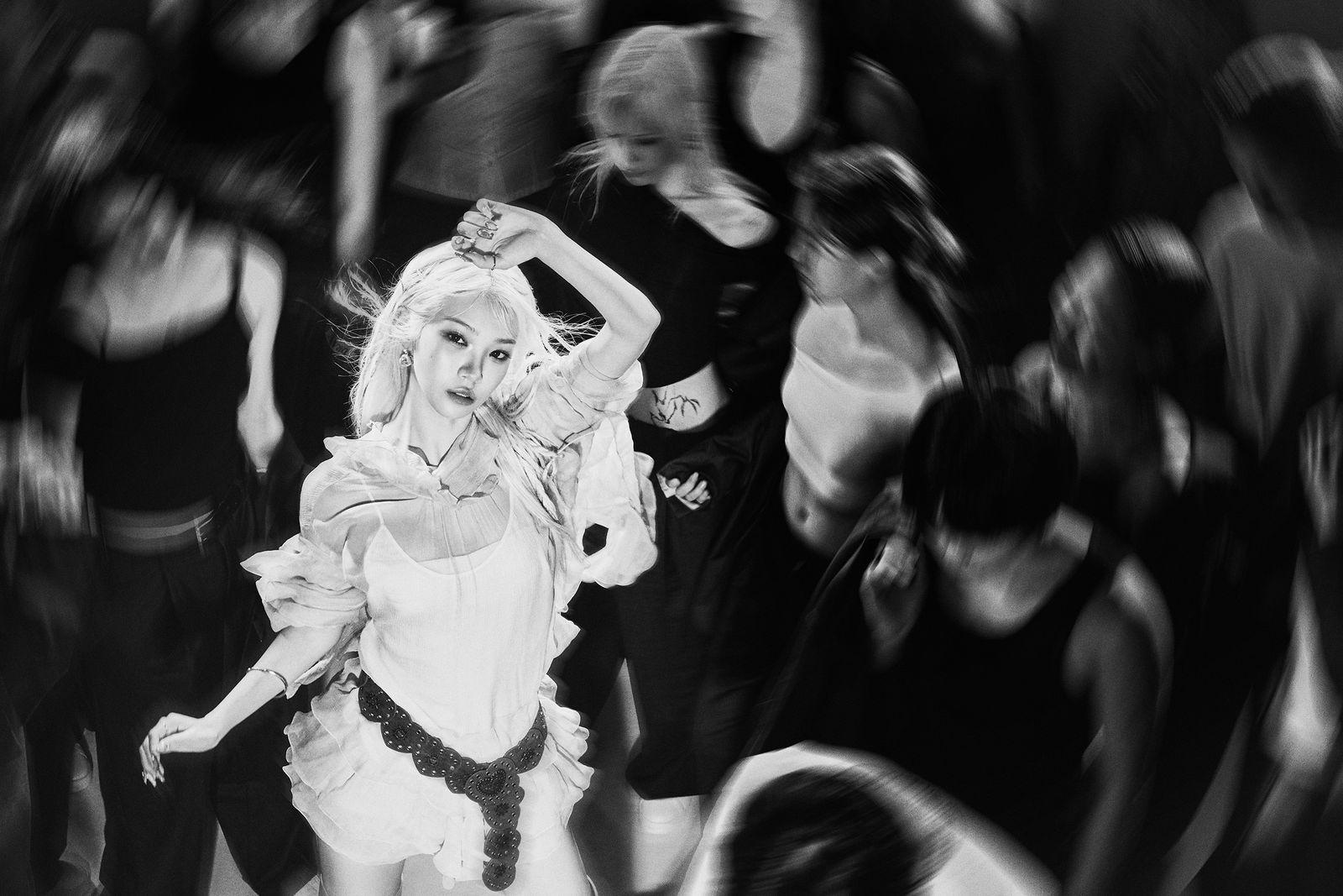 a black and white photo of a woman dancing