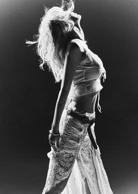 a woman in a long skirt is walking