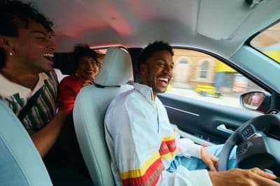 a group of people sitting in the back of a car