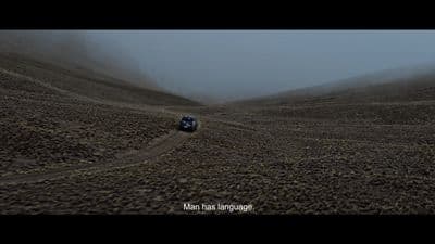 a truck is driving through a foggy desert