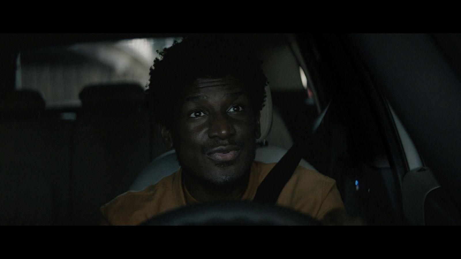 a man sitting in a car looking at the camera
