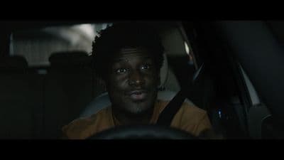 a man sitting in a car looking at the camera