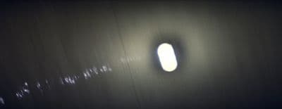 a dark room with a round window in it