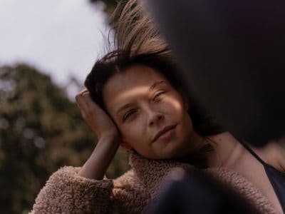 a woman with her hair blowing in the wind