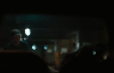 a blurry photo of a person in a car at night
