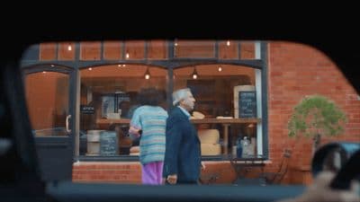 a couple of people that are standing in front of a building