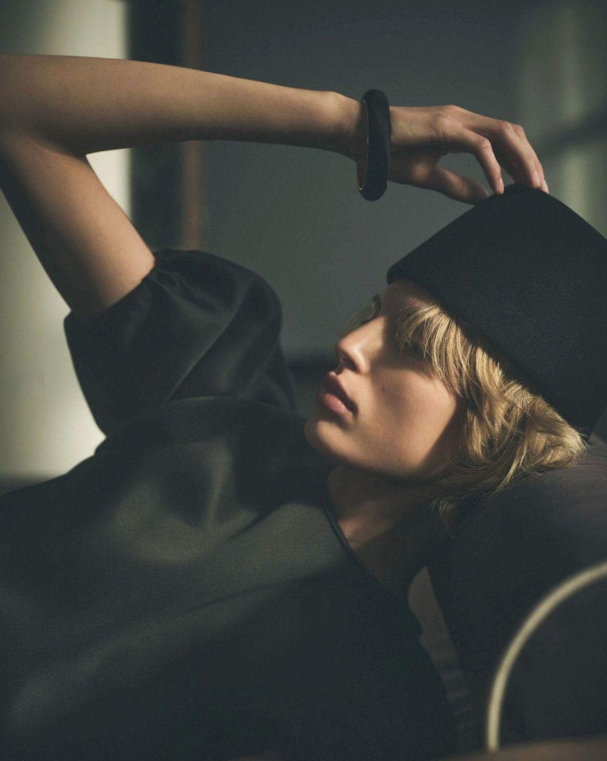 a woman with a black hat on her head