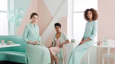 a group of women sitting next to each other in a room