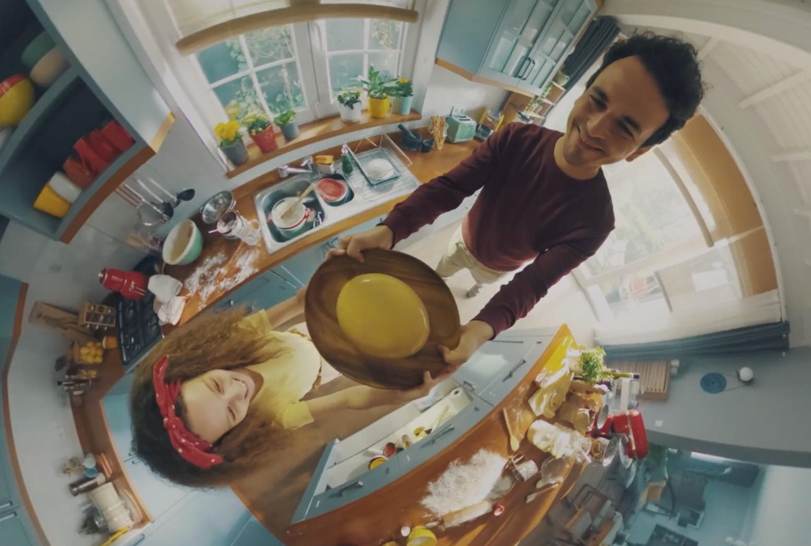 a man and a woman standing in a kitchen