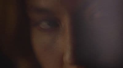 a blurry photo of a person's face with a cell phone