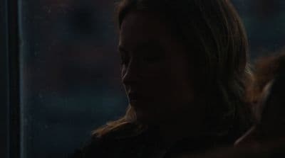 a woman looking out a window at the street