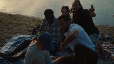 a group of people sitting on top of a blanket