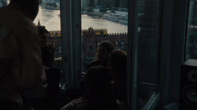 a group of people standing in front of a window