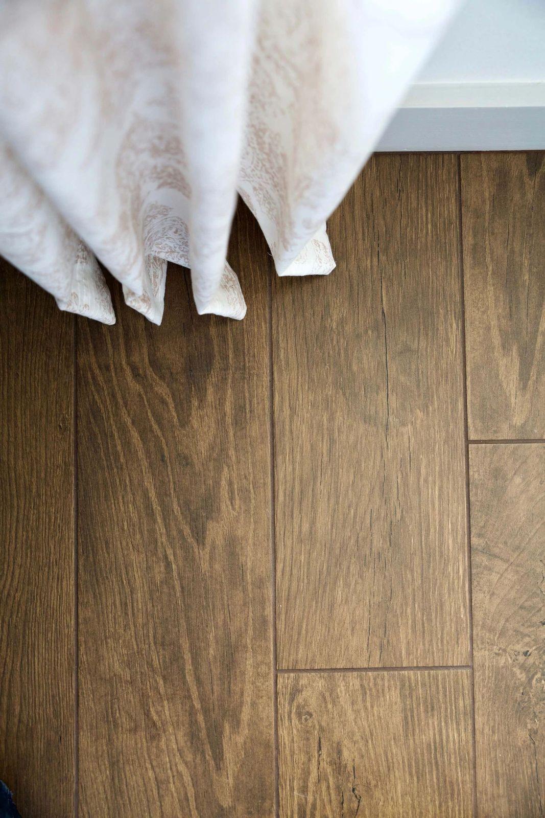 a close up of a person's feet on a wooden floor