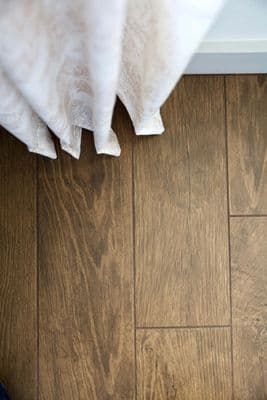 a close up of a person's feet on a wooden floor