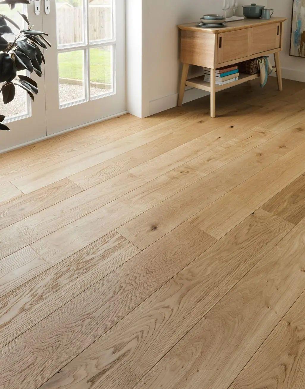 a living room with a wooden floor and white walls