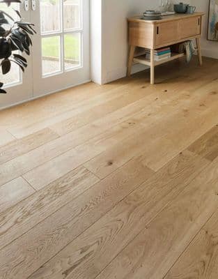 a living room with a wooden floor and white walls