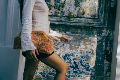 a woman is standing in front of a door