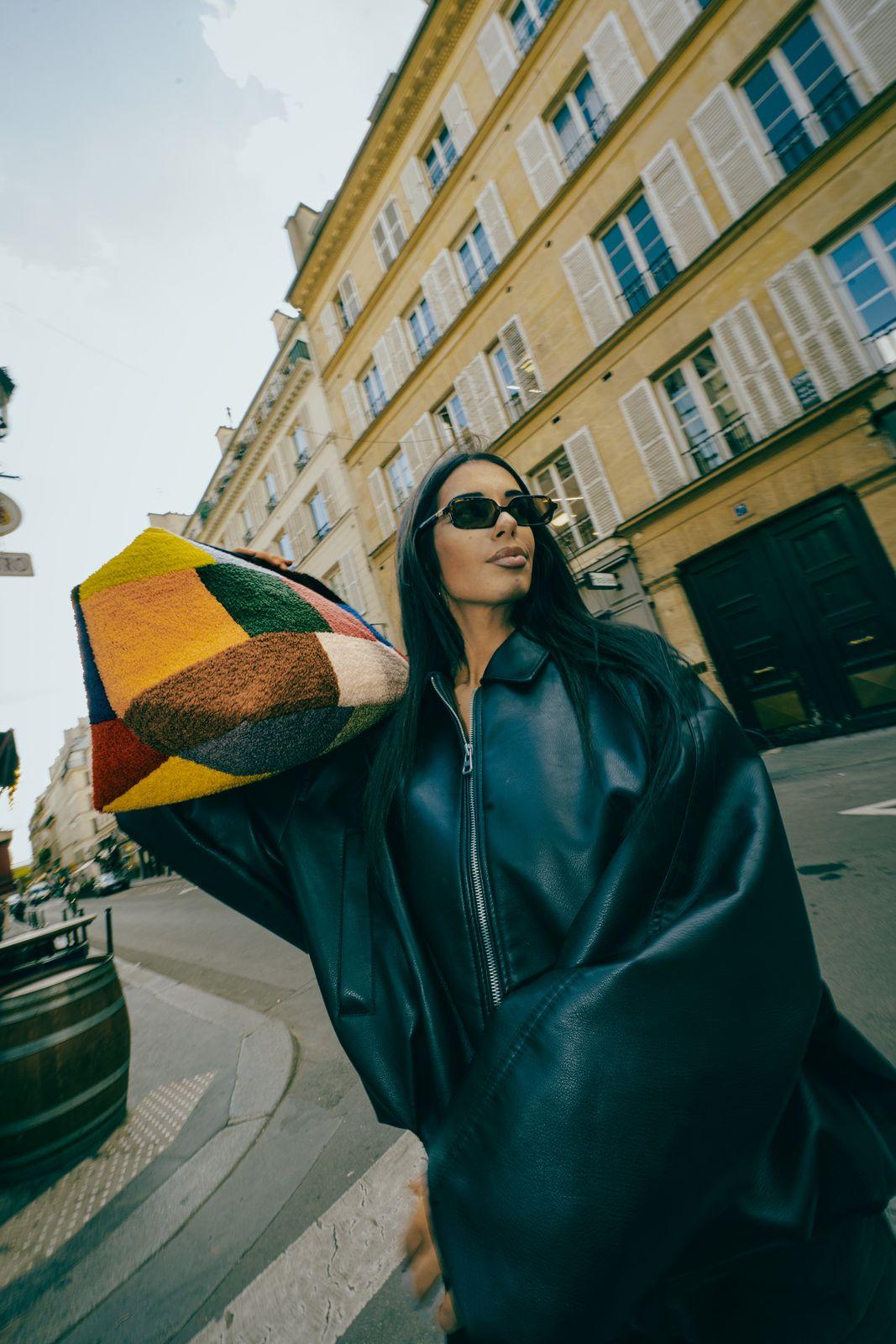 a woman wearing sunglasses and a black jacket