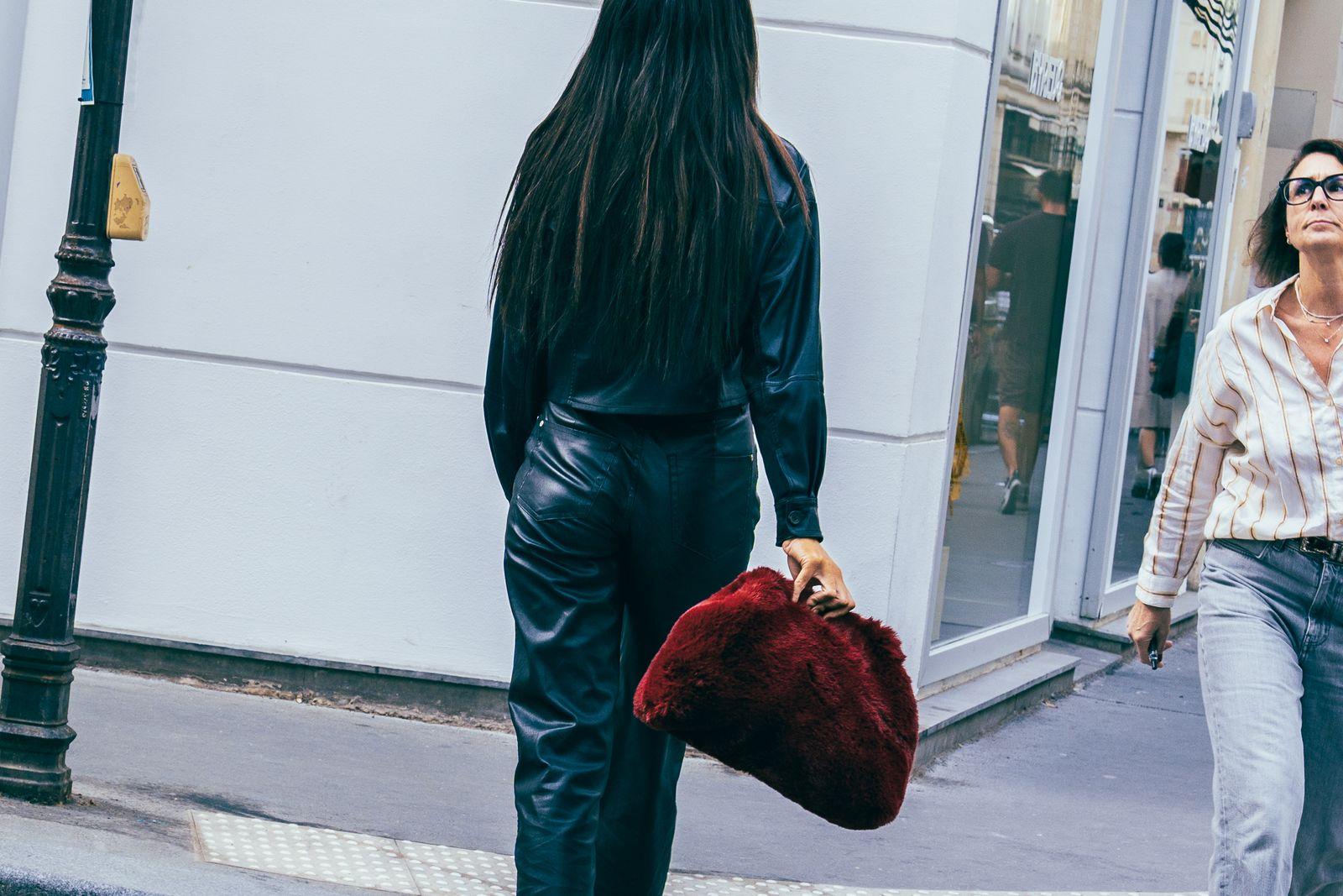 a woman walking down a street next to another woman