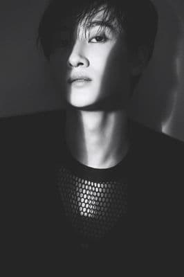 a person with a black shirt and a black and white photo