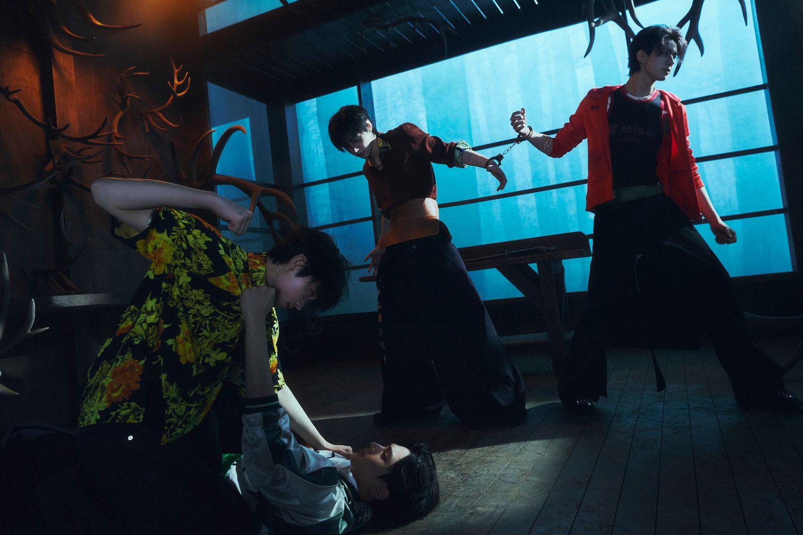 a group of people standing around each other in a room
