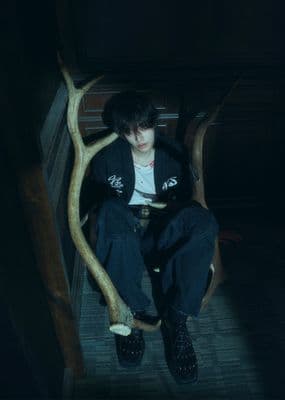a person sitting in a chair with a fake tree branch