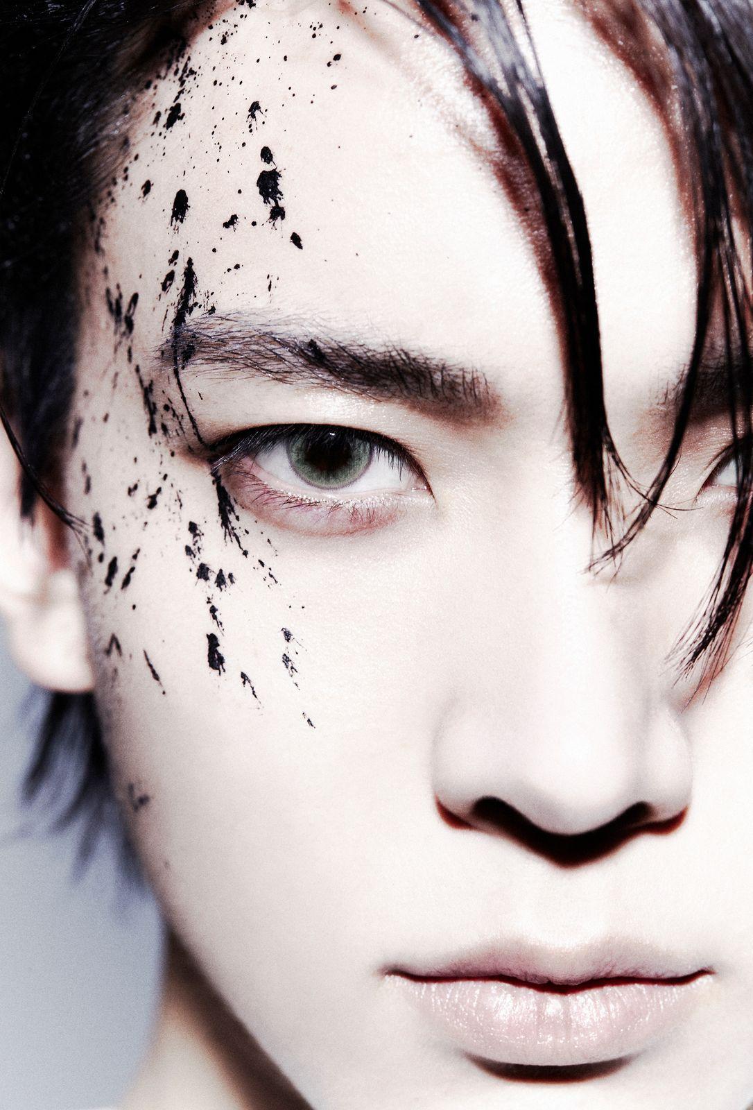 a close up of a person with black spots on his face