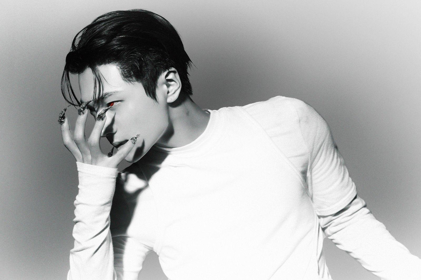 a man in a white shirt smoking a cigarette