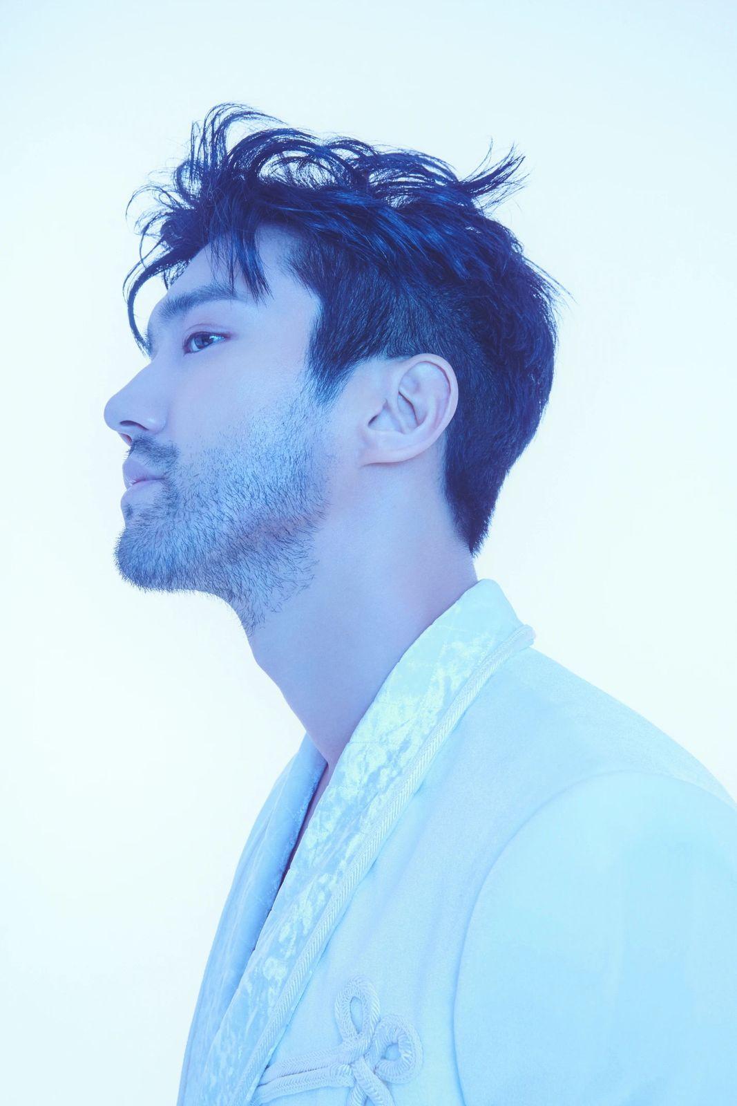 a man with black hair and a white shirt
