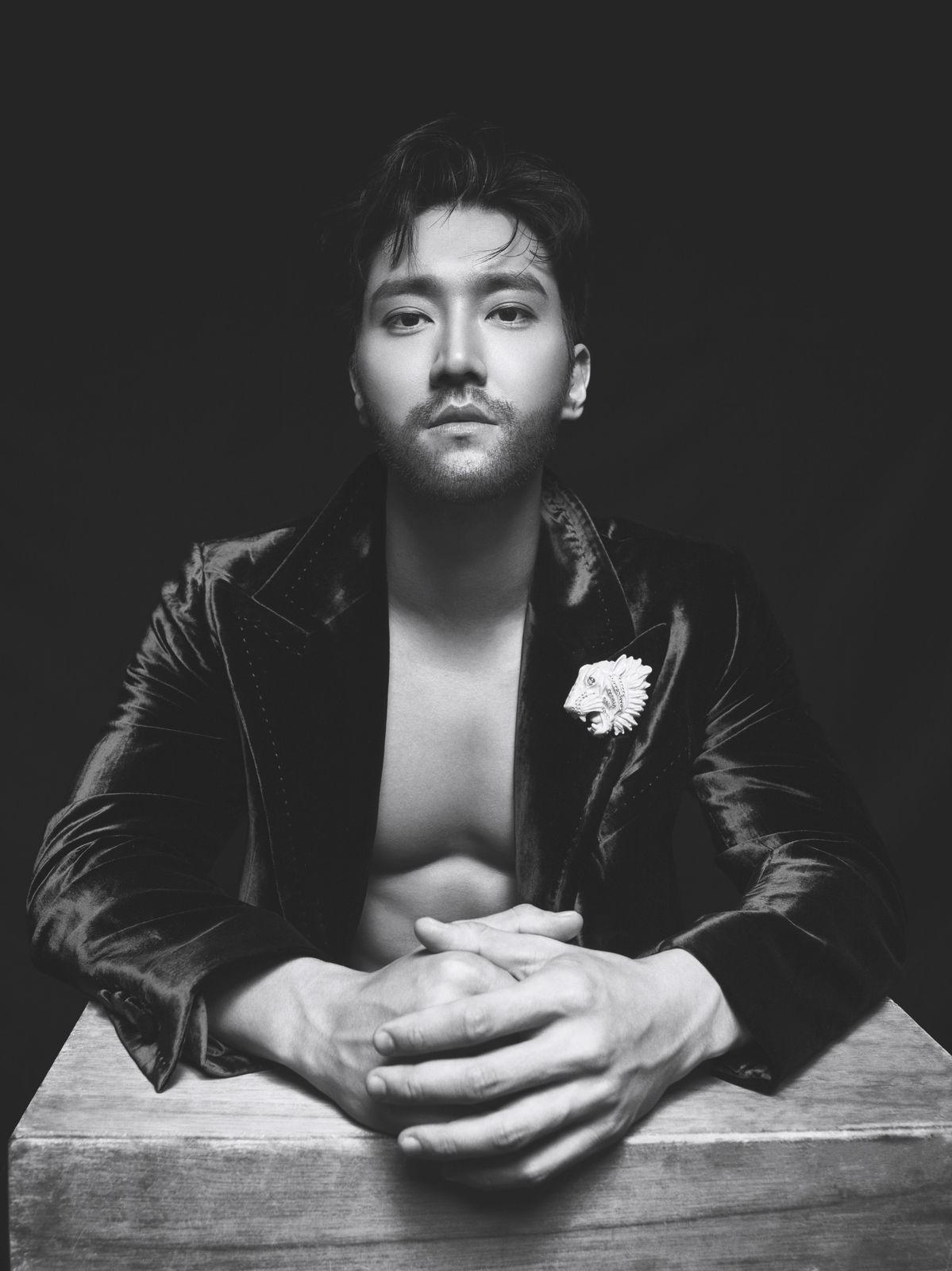 a man in a leather jacket is posing for a picture