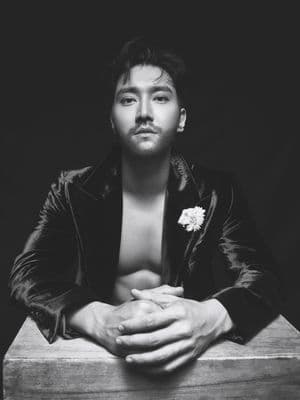 a man in a leather jacket is posing for a picture