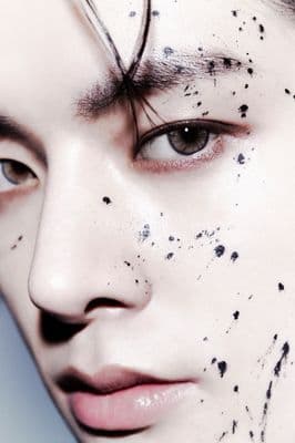 a close up of a person with black spots on his face