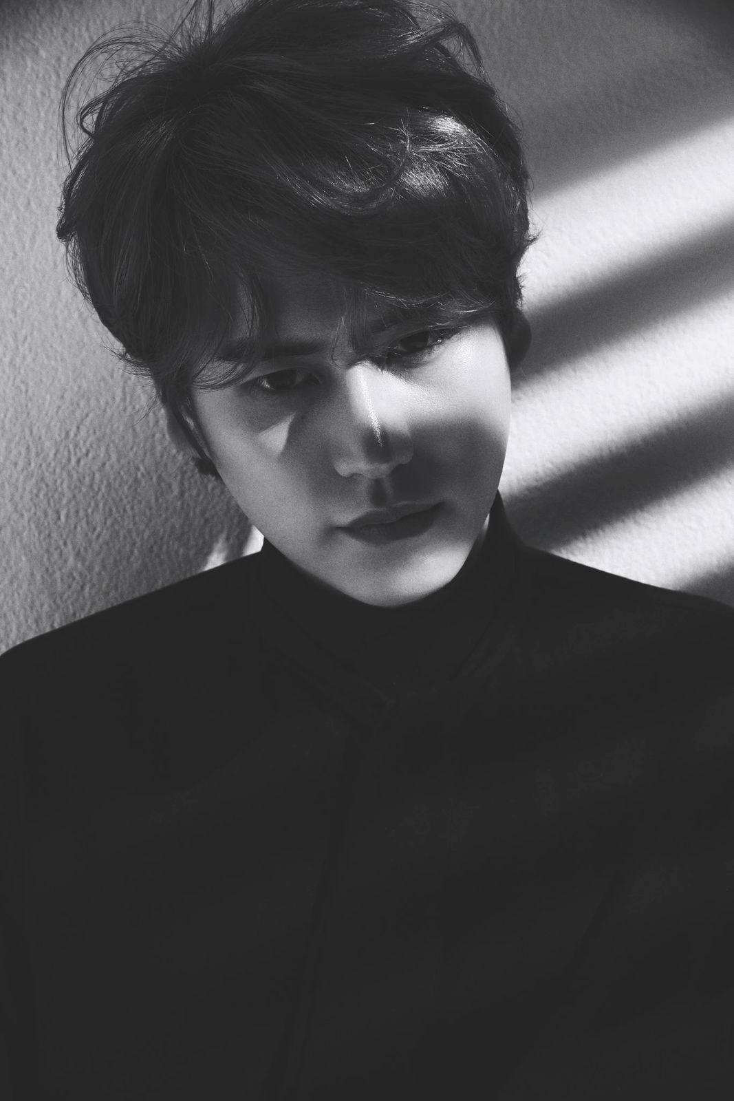 a person with a black shirt and a shadow on a wall