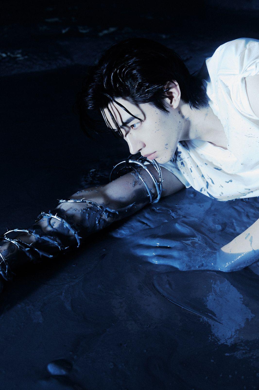 a woman laying on the ground with a knife in her hand