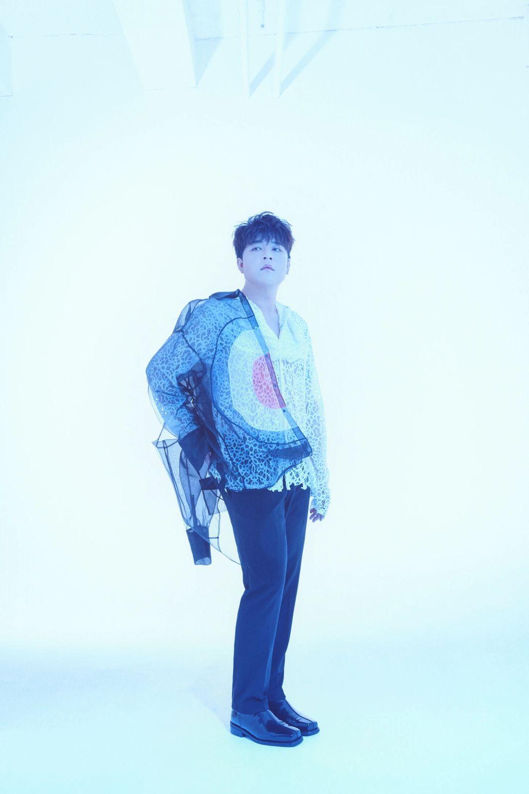 a man standing in front of a white background