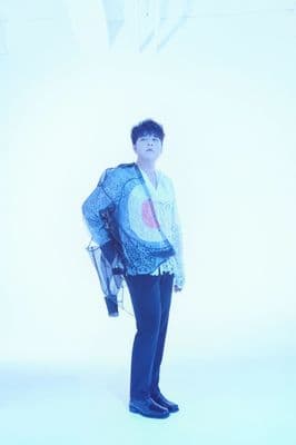 a man standing in front of a white background