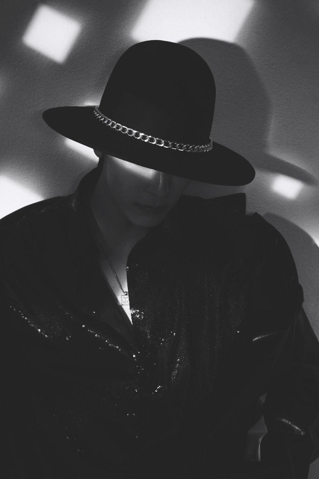 a woman wearing a black hat and jacket