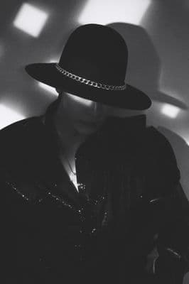 a woman wearing a black hat and jacket