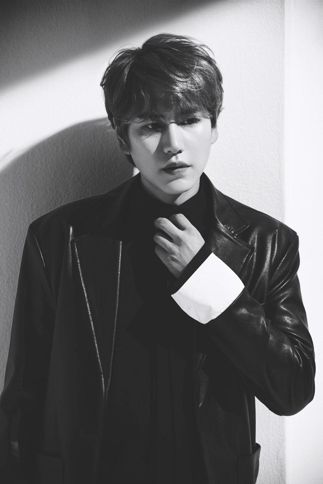 a young man in a leather jacket poses for a picture