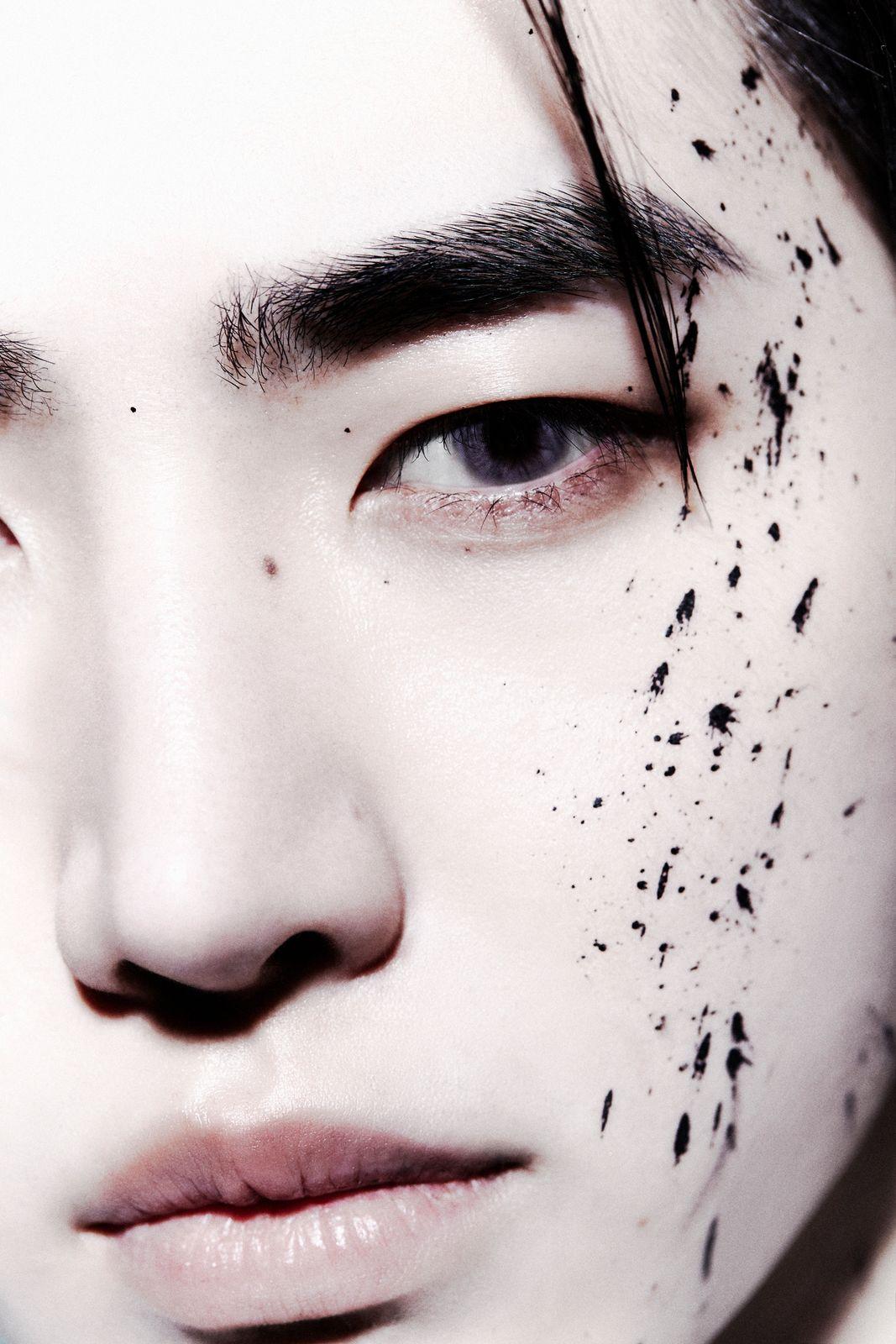 a close up of a person with black spots on his face