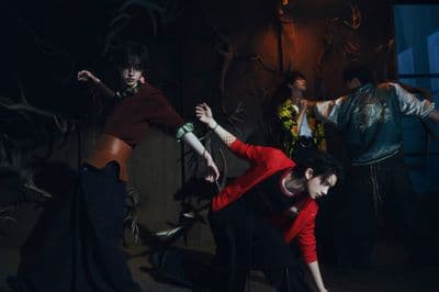 a group of people dancing in a dark room