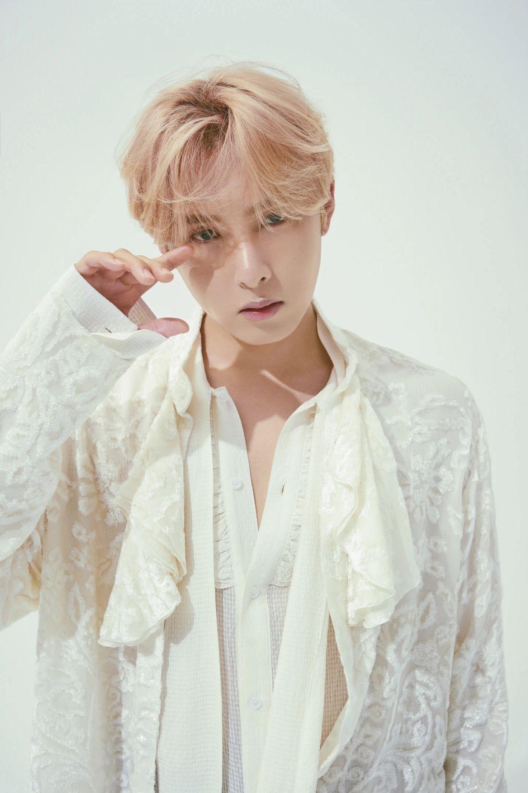 a man with blonde hair and a white shirt