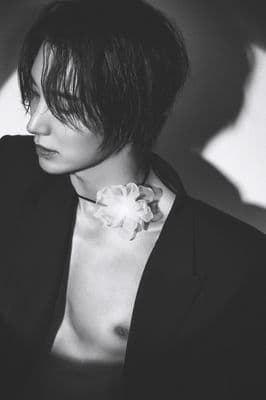 a black and white photo of a woman with a flower in her hair
