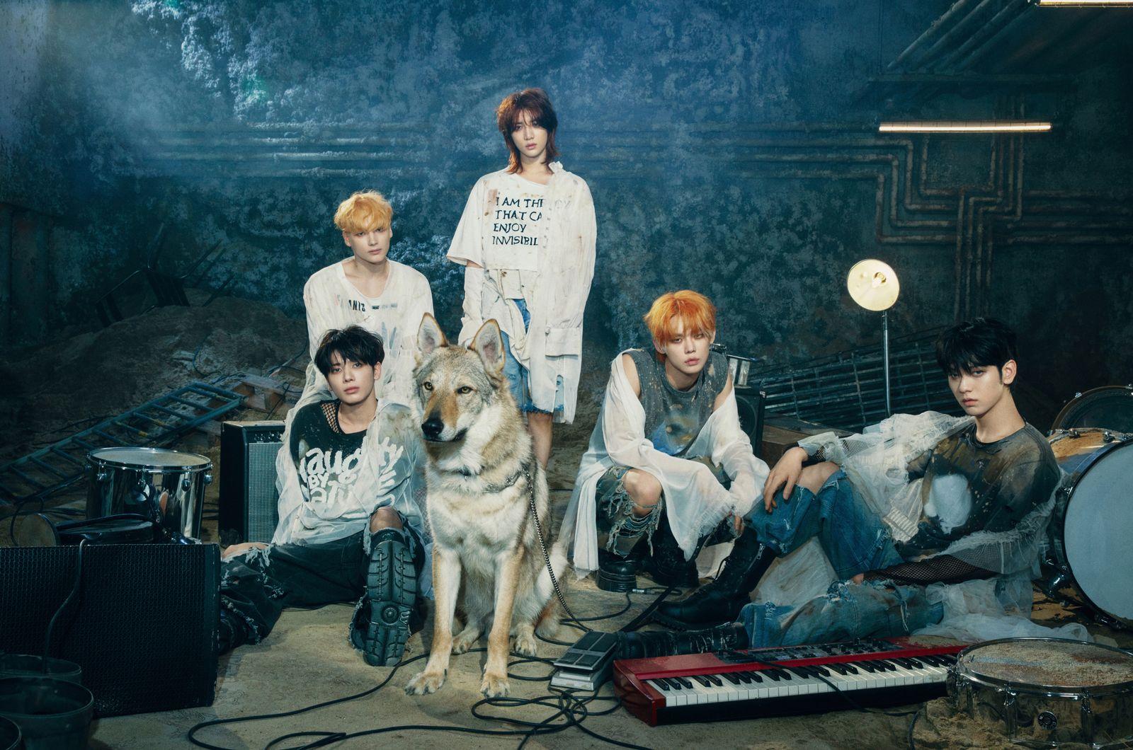 a group of young men sitting next to a dog