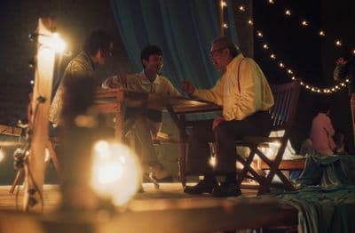 a group of men sitting around a wooden table