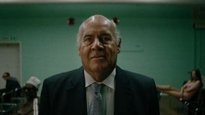 a man in a suit and tie standing in a room