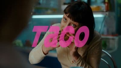 a woman holding a doughnut in front of her face